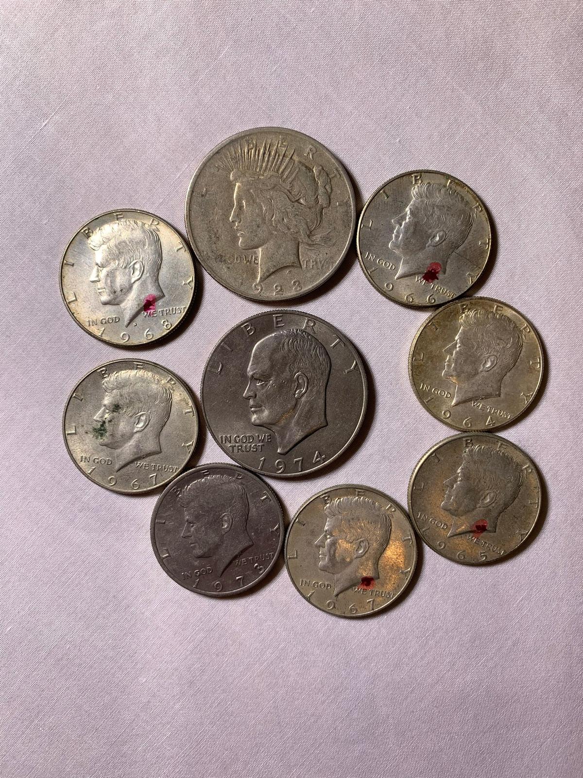 1 1923 Peace Dollar, 1 1974 Ike Dollar, & 7 Kennedy Half Dollars coins