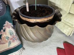 Upholstered chair and large metal planter