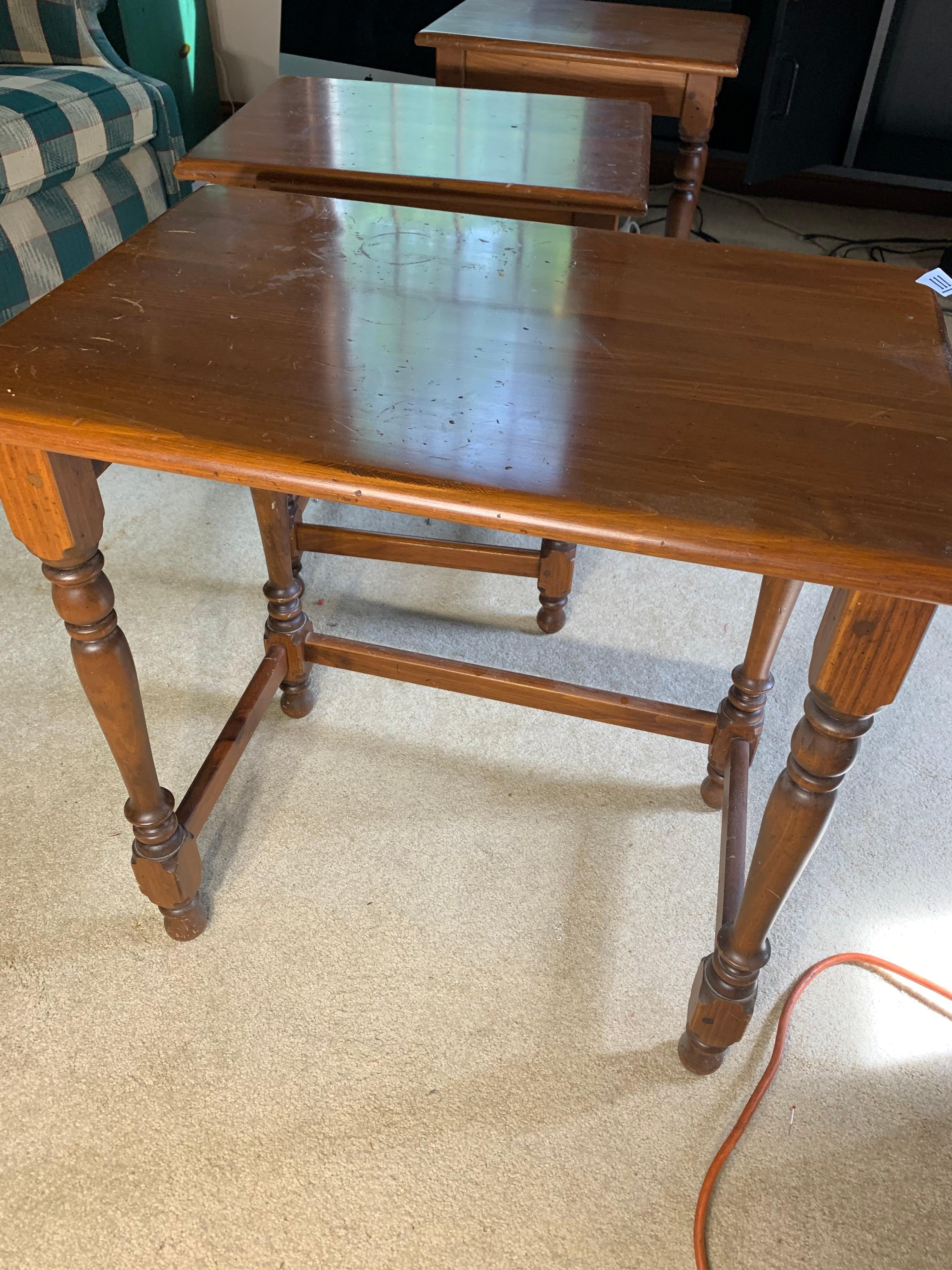 Four nesting wooden tables by Ethan Allen