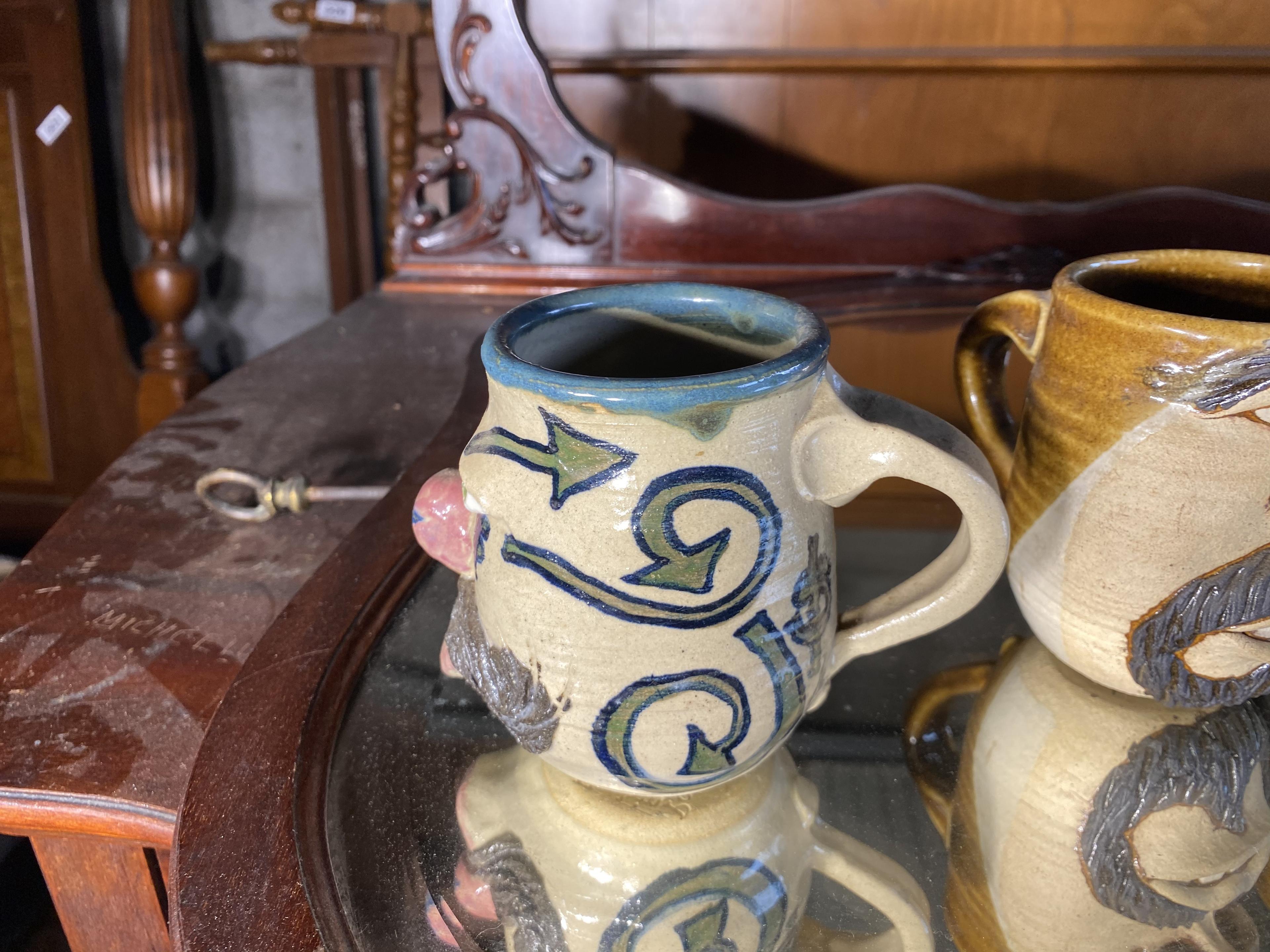 Group lot of four art pottery mugs