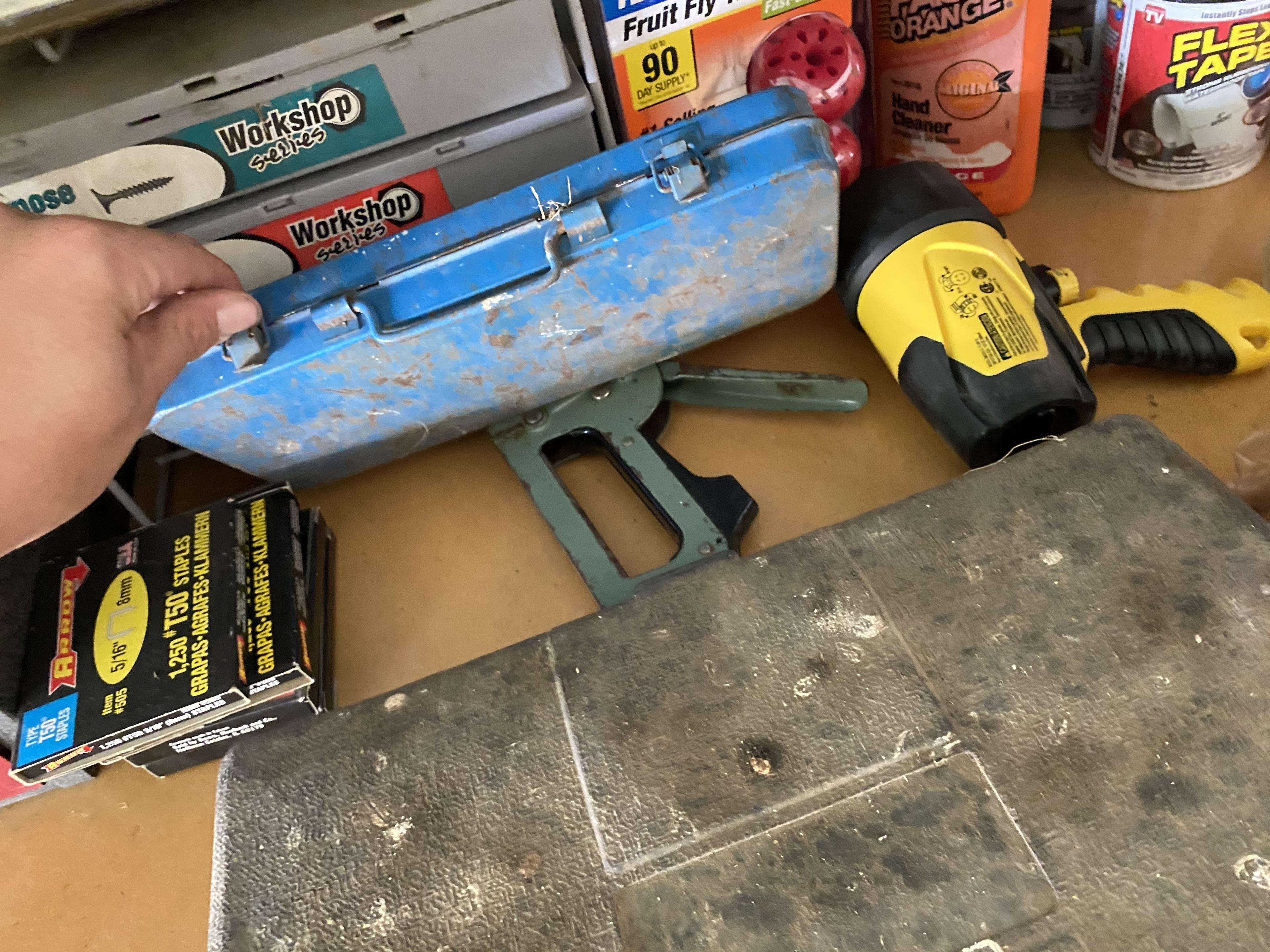 Items on right side of tool bench including anvil, plane in box