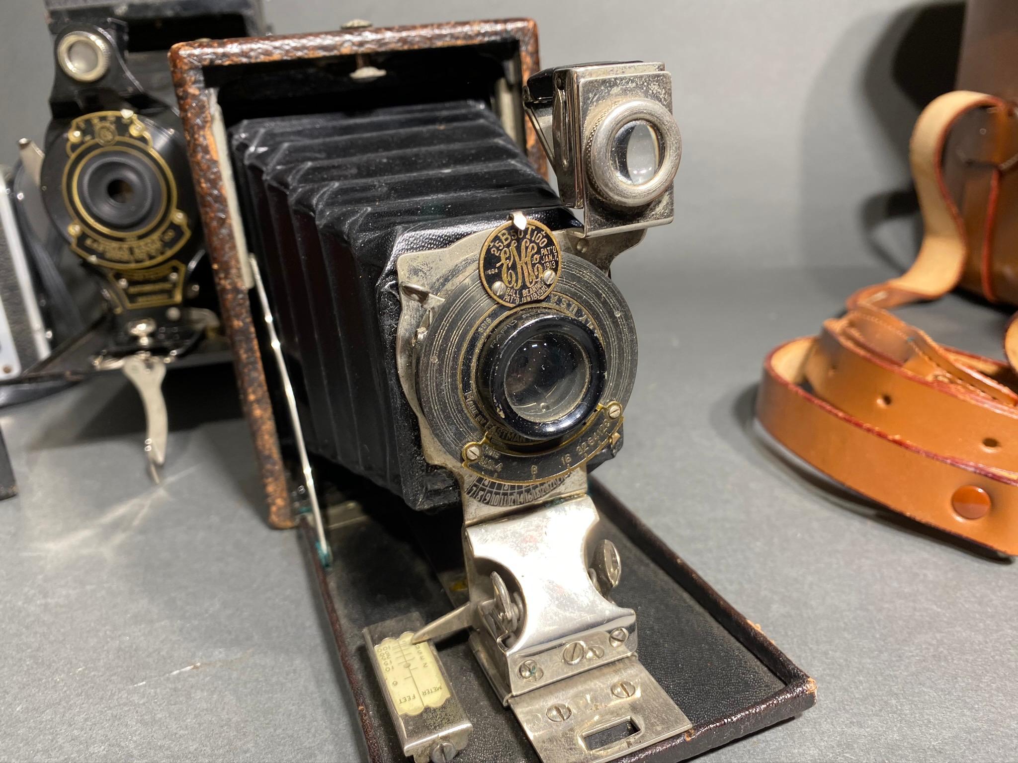 Group lot of antique cameras including red bellows