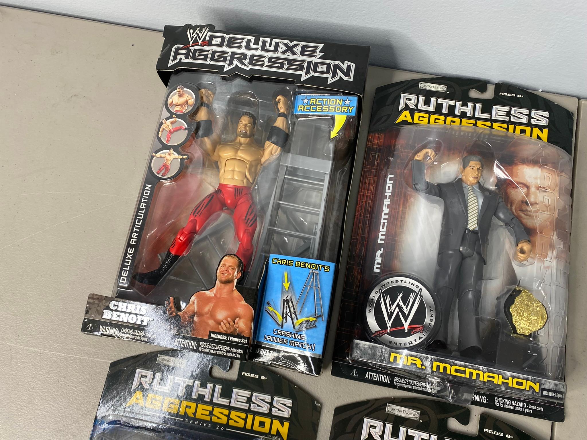 5 WWE Ruthless Aggression Action Figures and Justice League Action Figures New in Box.