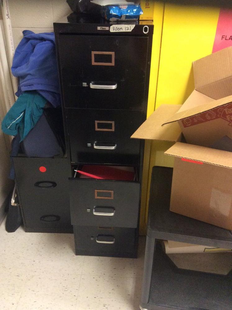 Small table and two chairs and a metal file cabinet