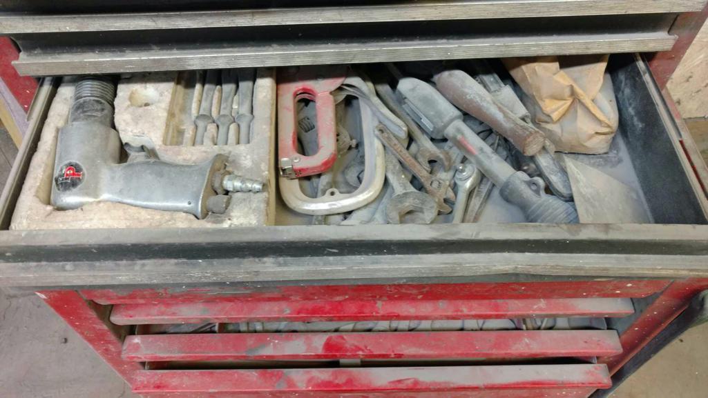 Tool cabinet with tools and files.