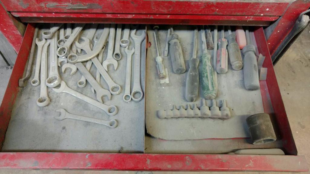 Tool cabinet with tools and files.