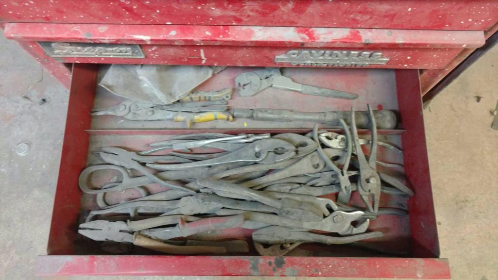 Tool cabinet with tools and files.