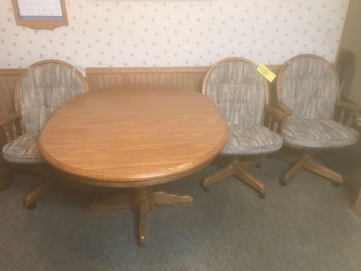 Oak table with four chairs and extra leaf