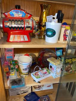 Contents of glass display cabinet, Las Vegas items, coffee mugs, bird clock, belt buckle, ashtrays