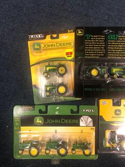Six packages of unopened John Deere miniature diecast tractors