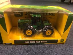 Two John Deere tractors in boxes