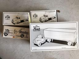 Four diecast toy trucks.