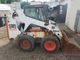 Bobcat S185 skid steer, diesel, and material bucket, 2,216 hours, spare tire