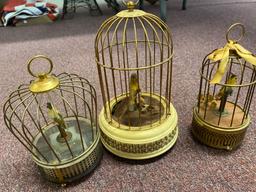 2 flats windup/battery operated singing birds in cages
