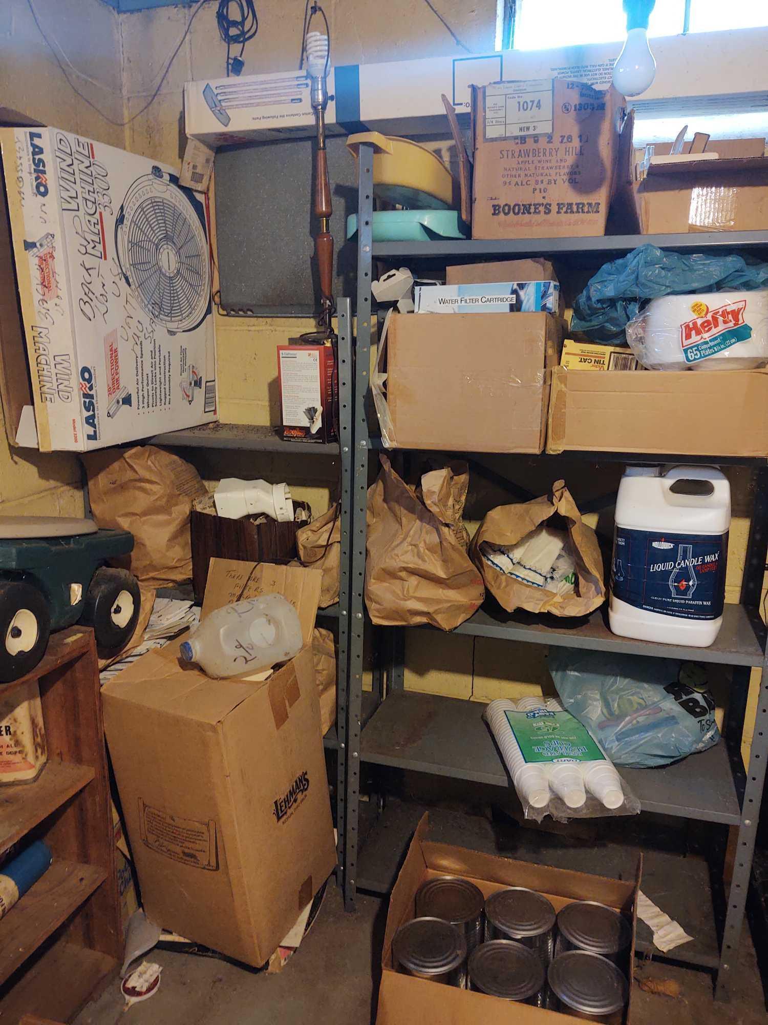 Contents of metal shelves: assorted paints, sprays, extension cords, styrofoam cups and plates