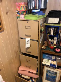 File cabinet, oil lamp, wooden shelf, and assorted desk items.