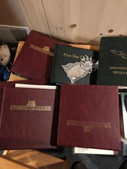 Assorted coin and stamp albums.