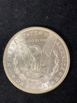 1883-O Morgan dollar, AU.