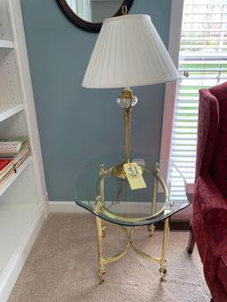 Claw foot wing back chair, brass and glass top side table, with brass lamp, oval mirror