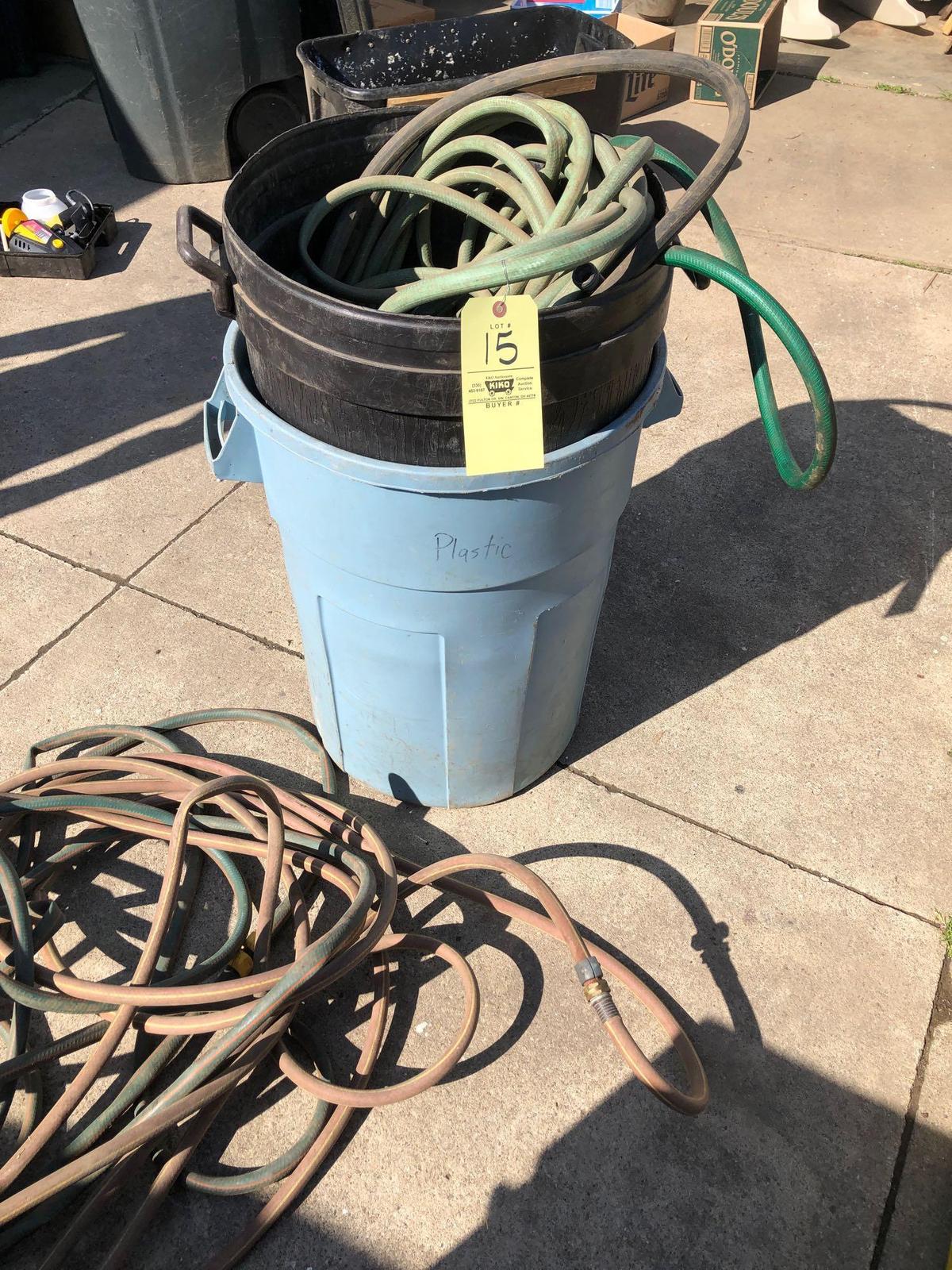 Garden hose and 2 trash cans