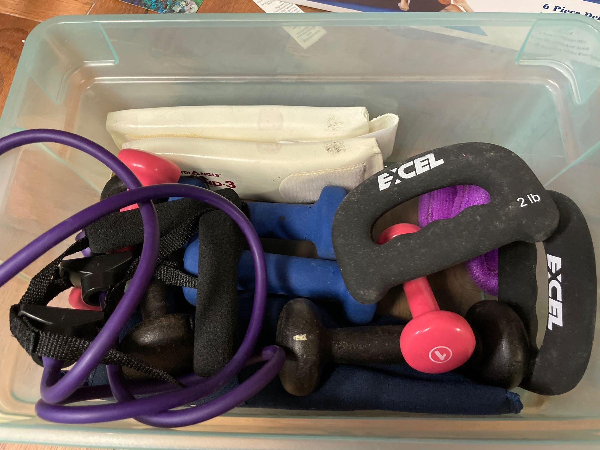 Tote full of exercise weights and straps, Pilates kit
