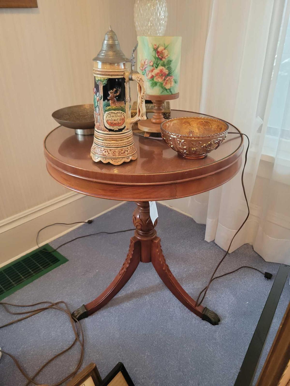 Round carved lamp table with glass top