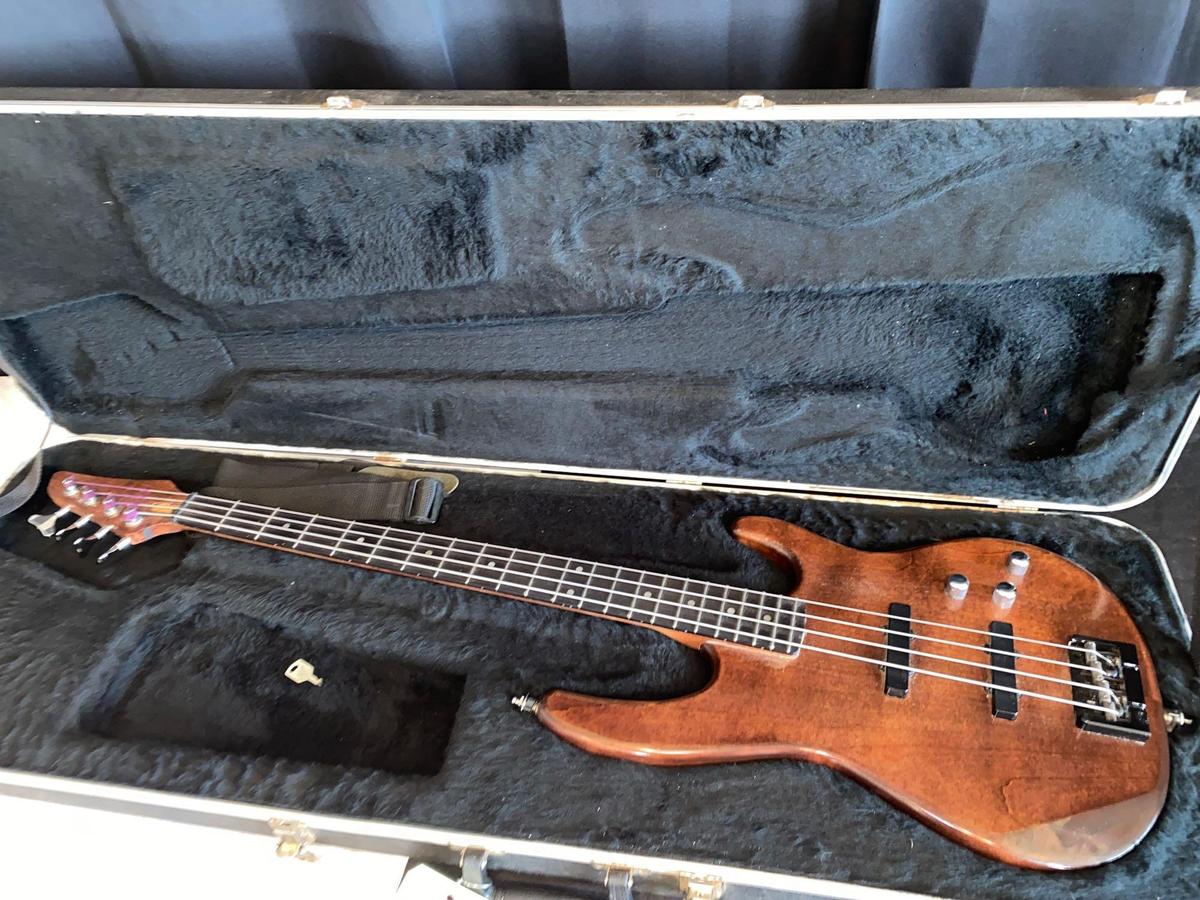 Wooden guitar w/ Carvin hard travel case.