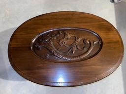 Glass top coffee table w/ cornucopia carved top, 32" long x 22.5".