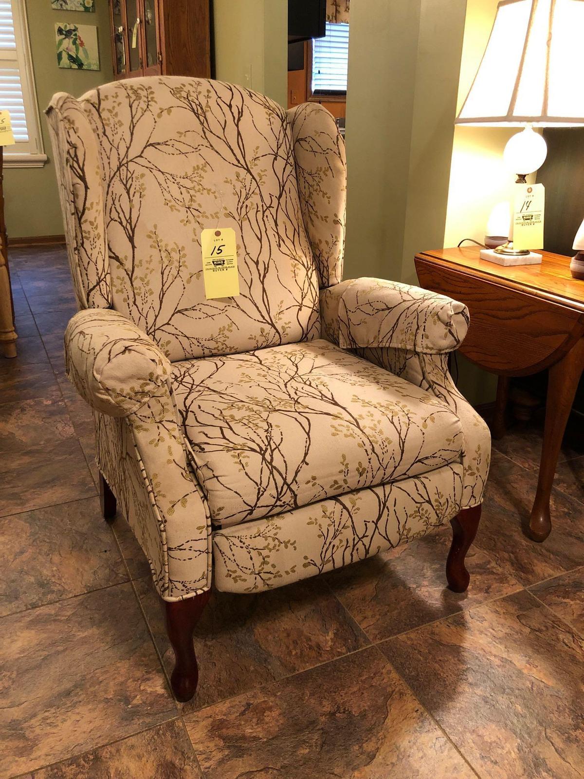 Upholstered reclining armchair