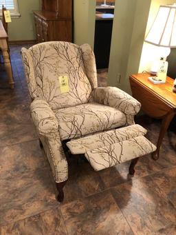 Upholstered reclining armchair