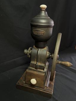 Hand crank coffee grinder on wood base