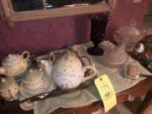Teapot set, covered hen vase, covered glass and egg.