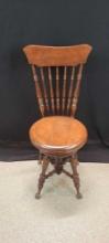 Antique piano stool with high back and claw and ball feet