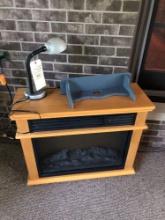 electric fireplace, small shelf and table lamp