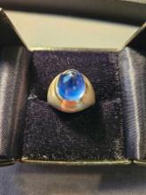 Ladys 10k white and yellow gold ring with a blue bullet shaped sapphire cabochon