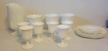 Milk glass pitcher set, plates, and compotes