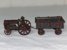 Cast iron tractor & cast iron wagon, each 3 3/4" long.