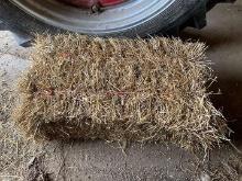 25 small square bales of wheat straw stored inside