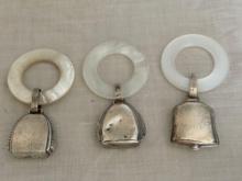 Sterling baby bell rattles w/ mother of pearl handles.