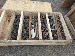 Wooden crate of piping pieces.