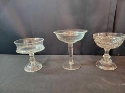 Assorted press glass compotes and gold rim drinking glasses