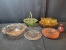 Green glass basket, pink depression plates, amber glass cups and plates