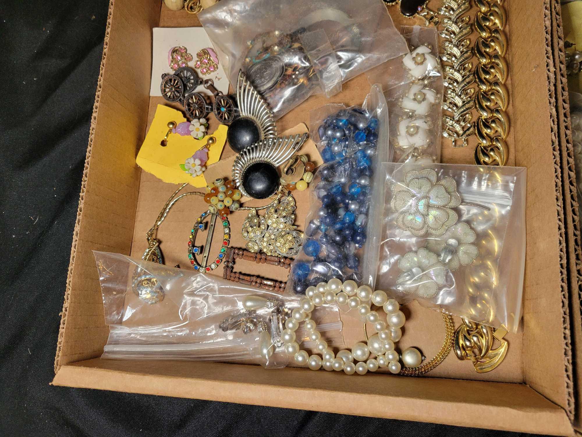 Group of assorted costume jewelry, pins, necklaces, brooches and earrings