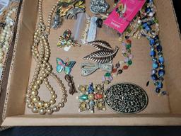 Group of assorted costume jewelry, pins, necklaces, brooches and earrings