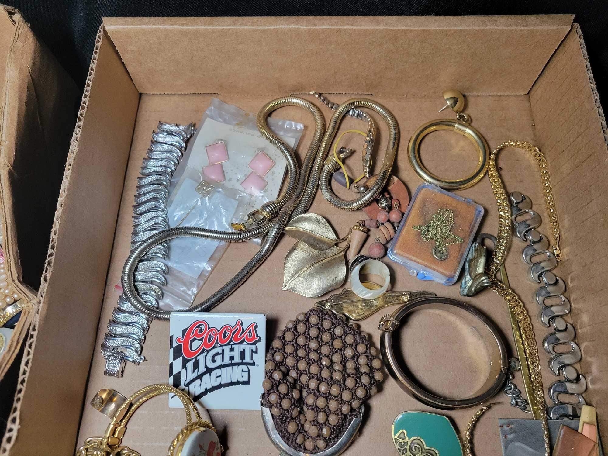 Group of assorted costume jewelry, pins, necklaces, brooches and earrings