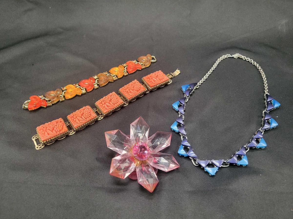 Colorful plastic costume jewelry bracelets, necklace and brooch