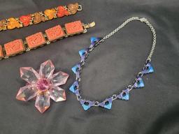 Colorful plastic costume jewelry bracelets, necklace and brooch