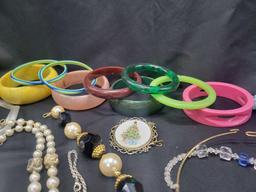Lot of plastic bangles, sterling heart pendant, necklaces and more