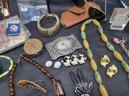 Lot of plastic bangles, chinky tiger eyes necklace, celluloid hair combs brooches and more