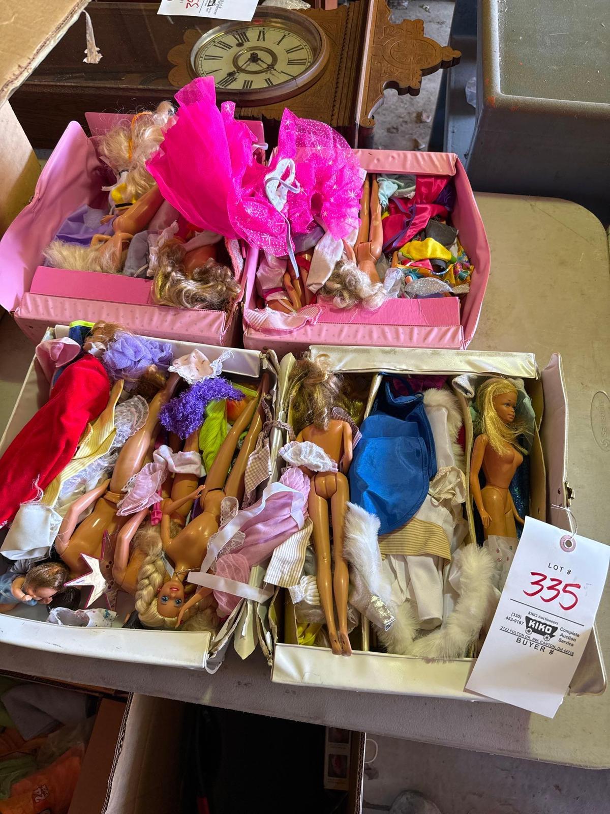two boxes of assorted Barbie dolls